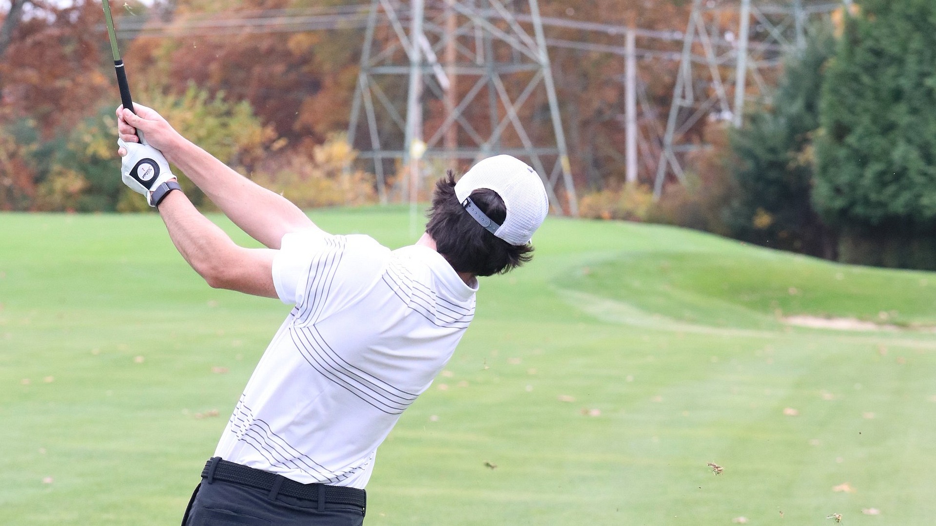 Dylan Gallagher following through on his swing 