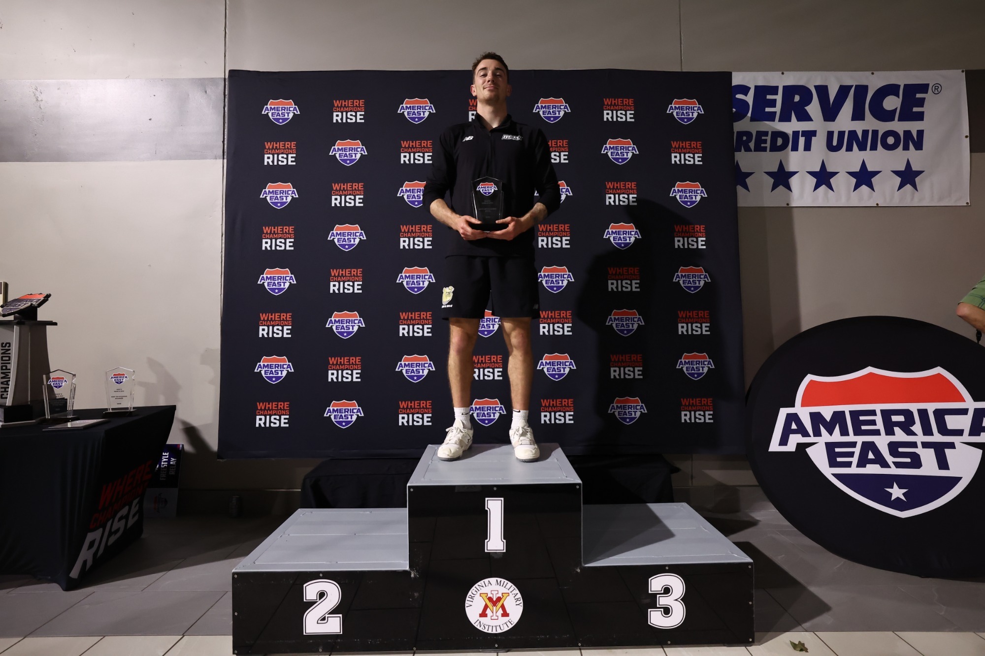 Chris Buonocore Stands on stage with his award