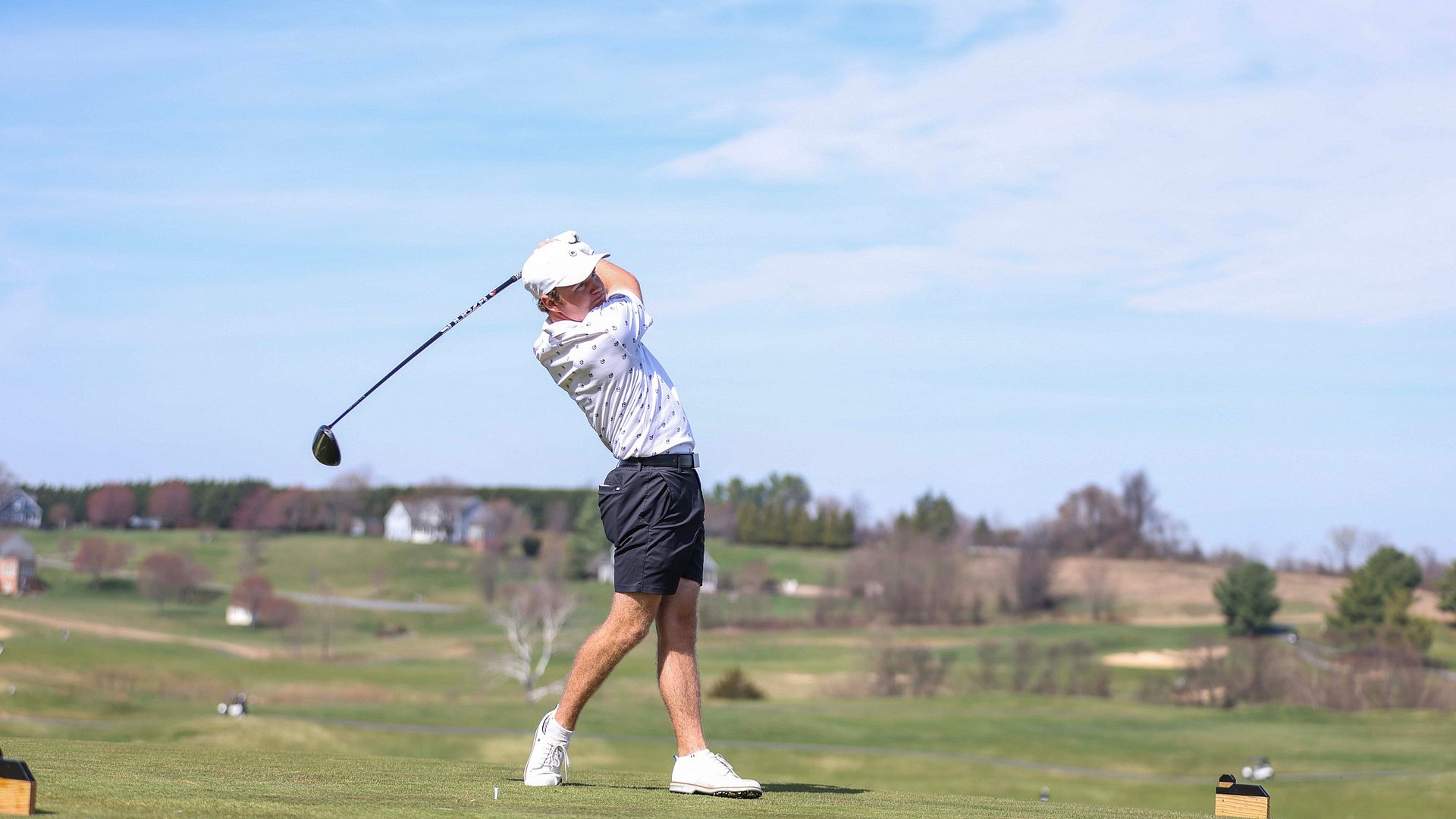 Chad Correia following through on his golf swing in Carpetbagger Classic