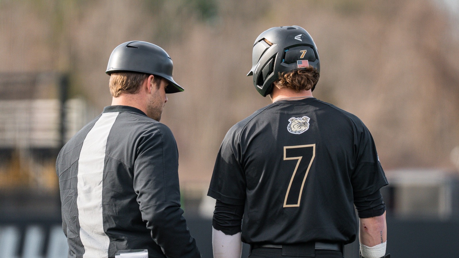 Gavin Greger stands with Coach at first base vs NJIT