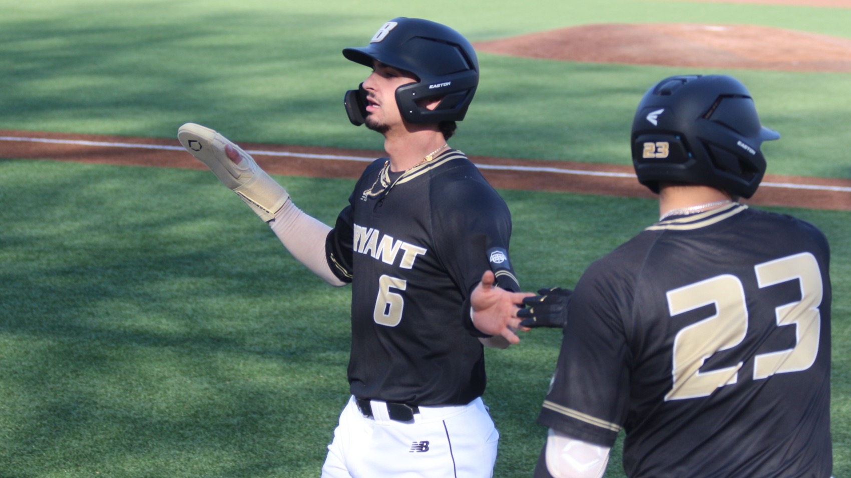 Casey Wensley High Fives his teammates after scoring a run
