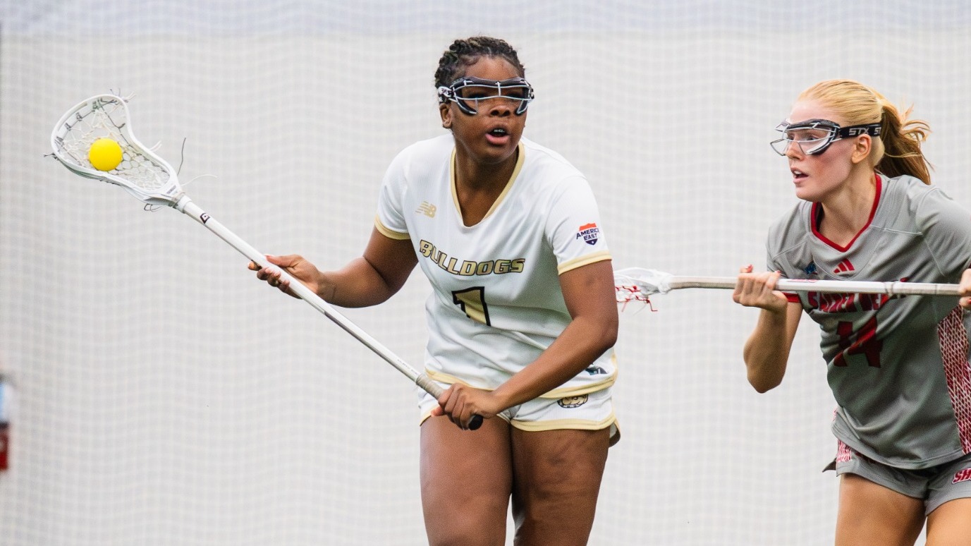 Sydnee Denson Craddles the ball against a Sacred Heart defender