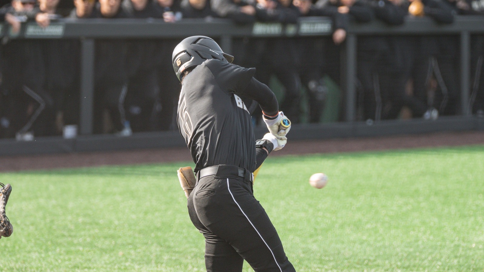 Casey Wensley swings and hits a ball vs NJIT