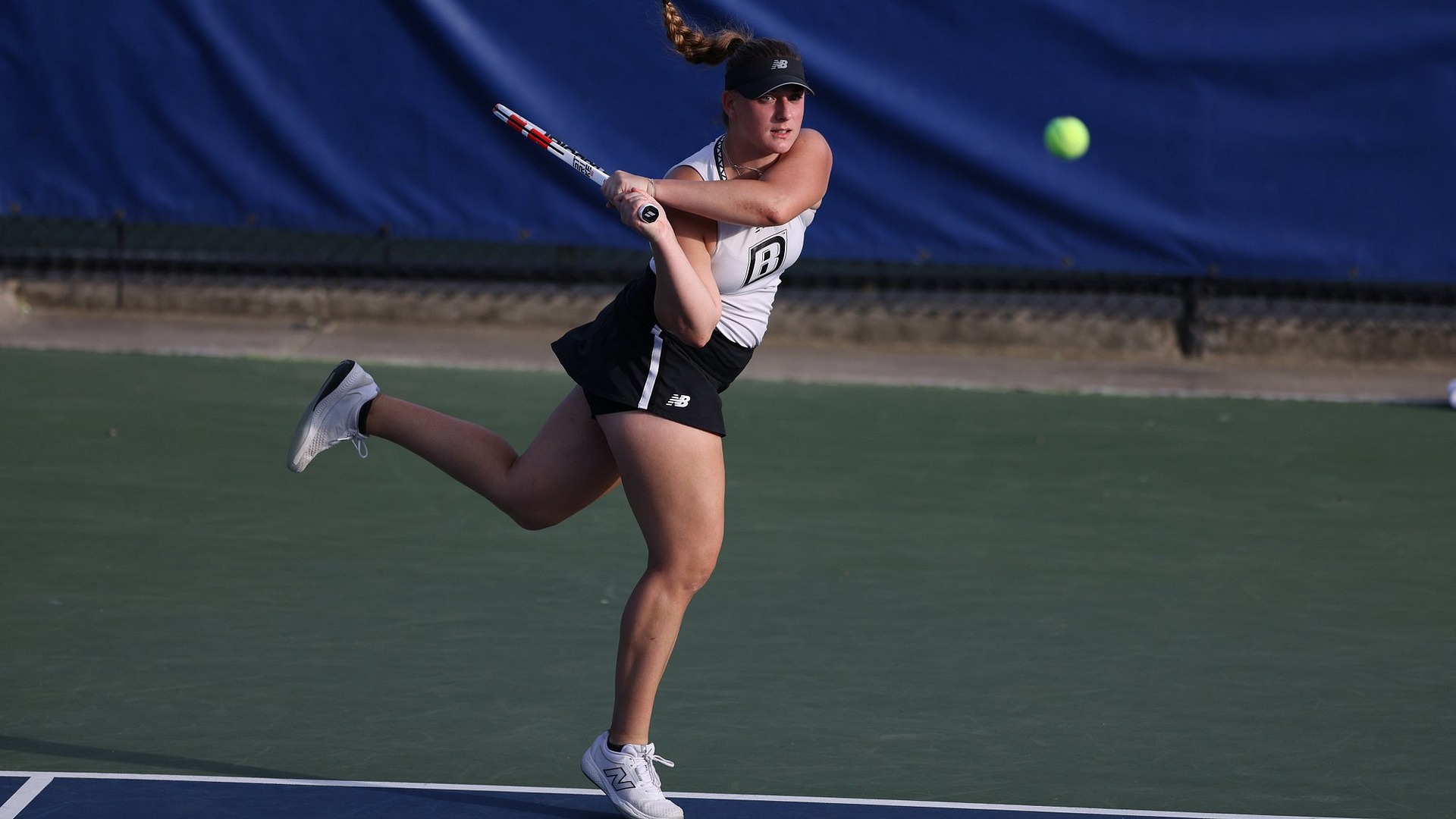 Lisa Dugec hitting a backhand shot