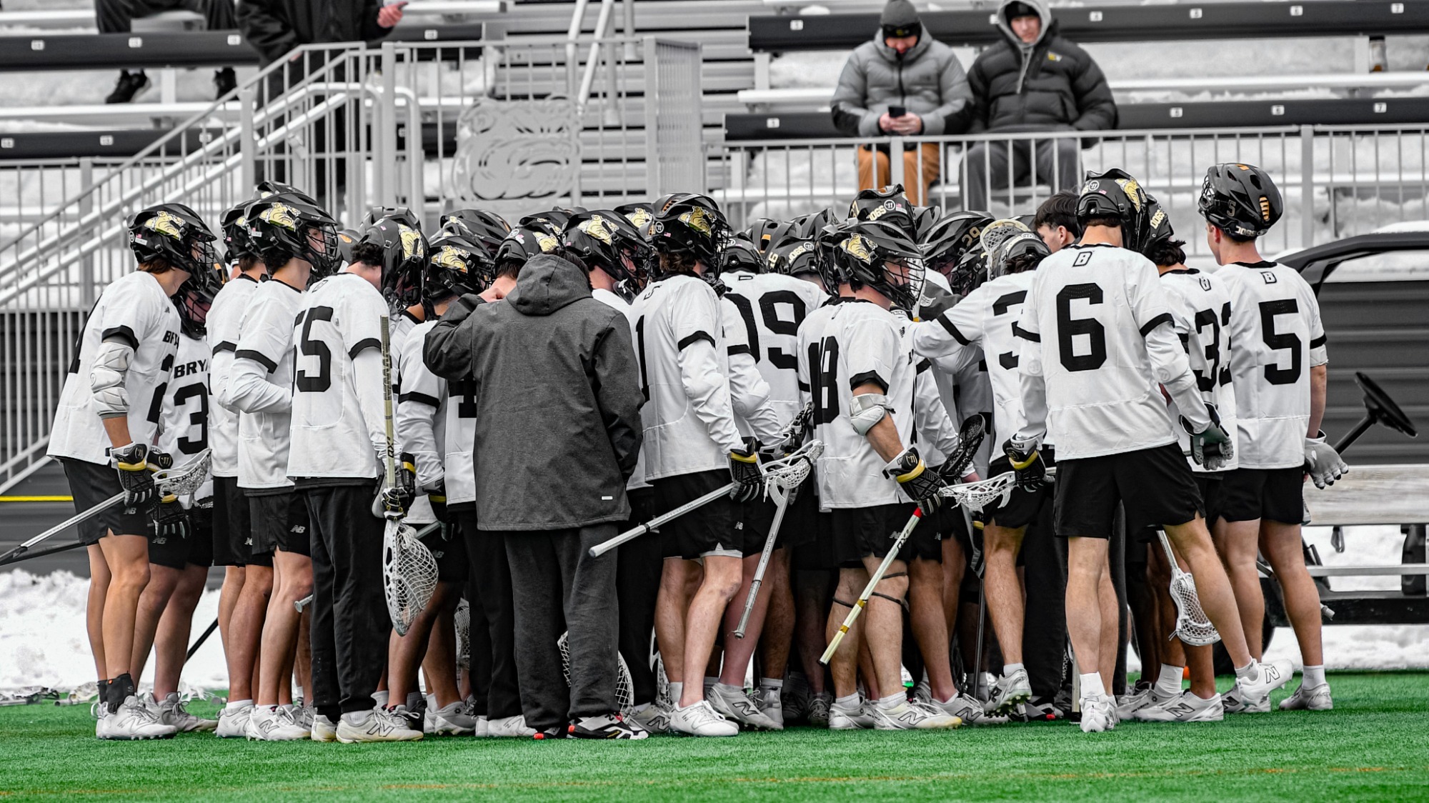 men's lacrosse team huddle