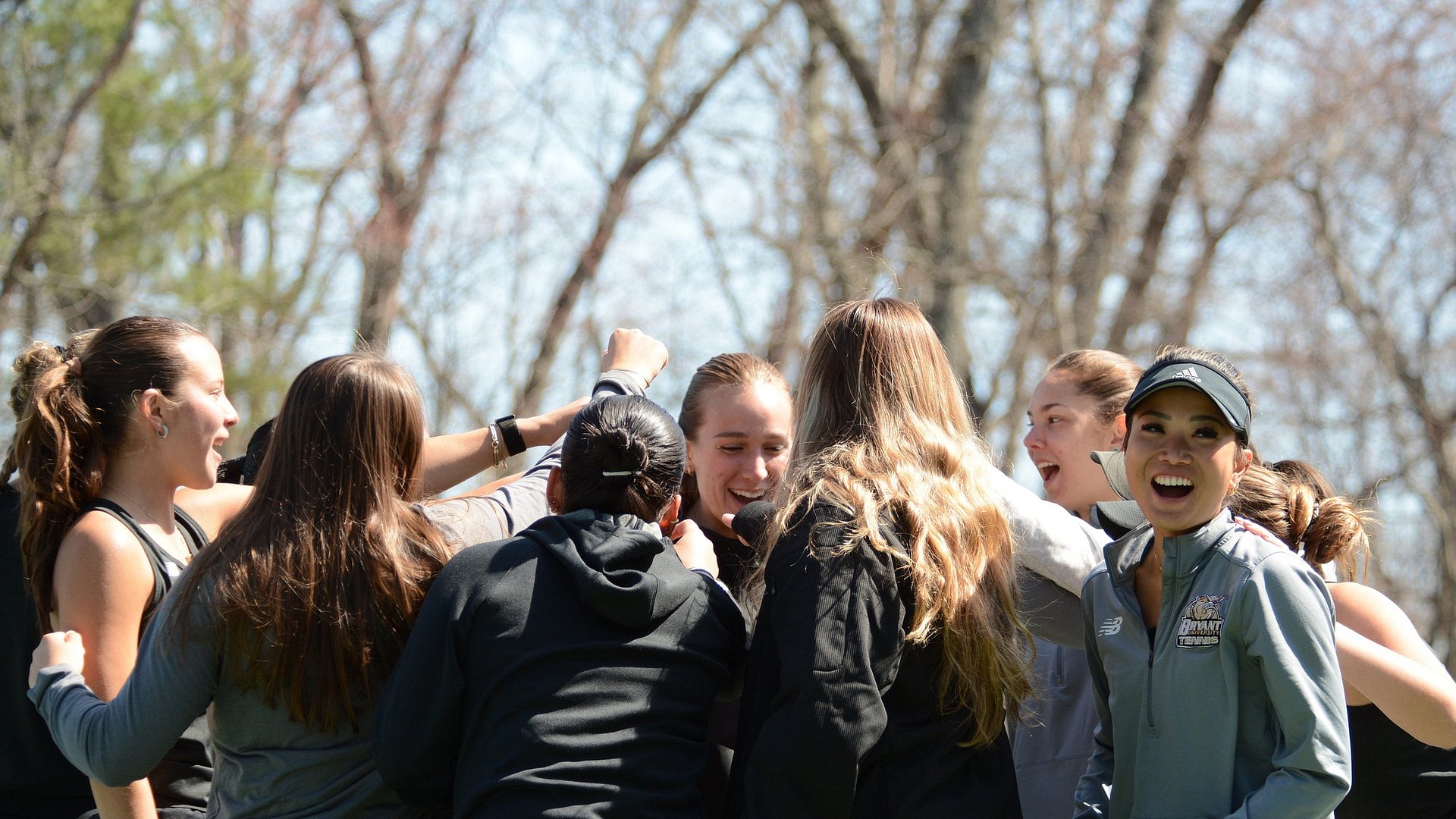 Women's Tennis team huddle before match against New Haven