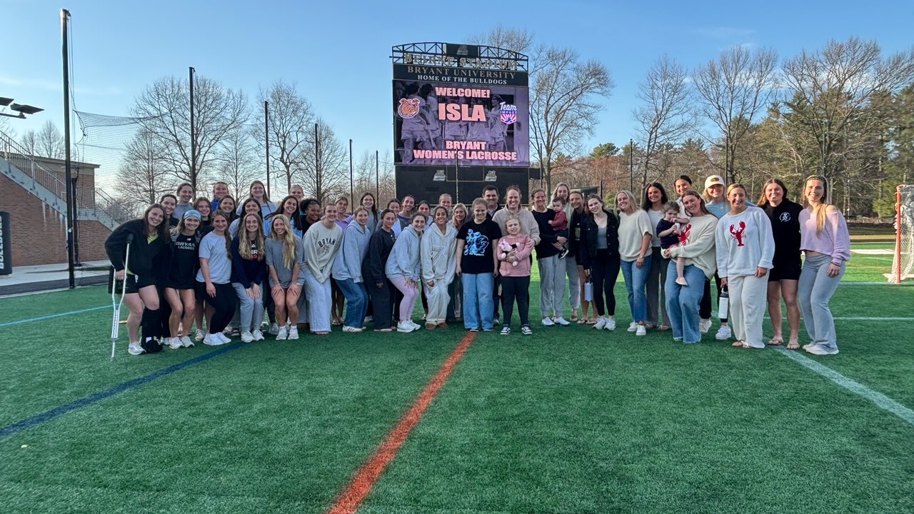 Womens lacrosse poses with their new team impact teammate