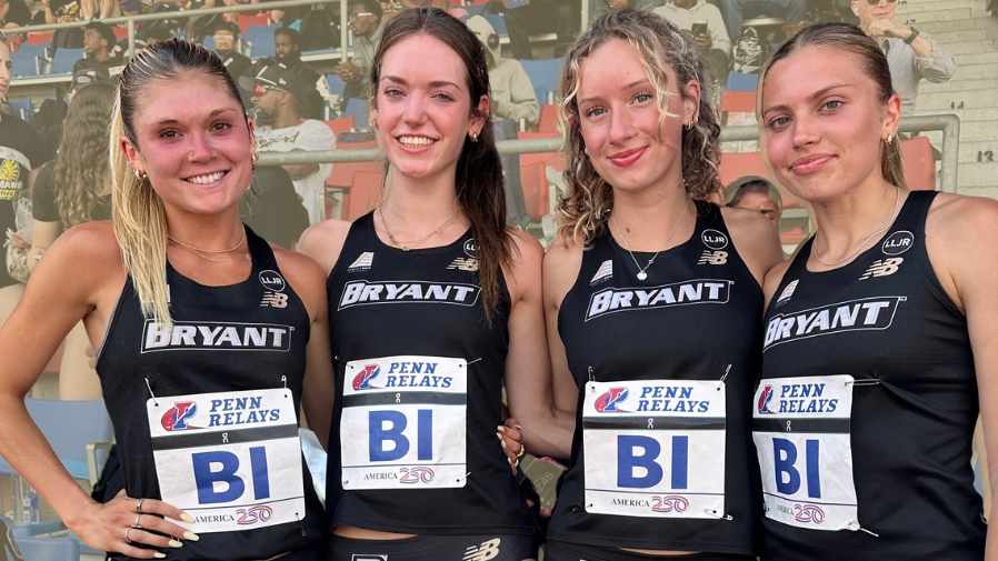 Whiting, MacElhiney, Haddad and Guadagnoli smiling and standing shoulder-to-shoulder during at the Penn Relays