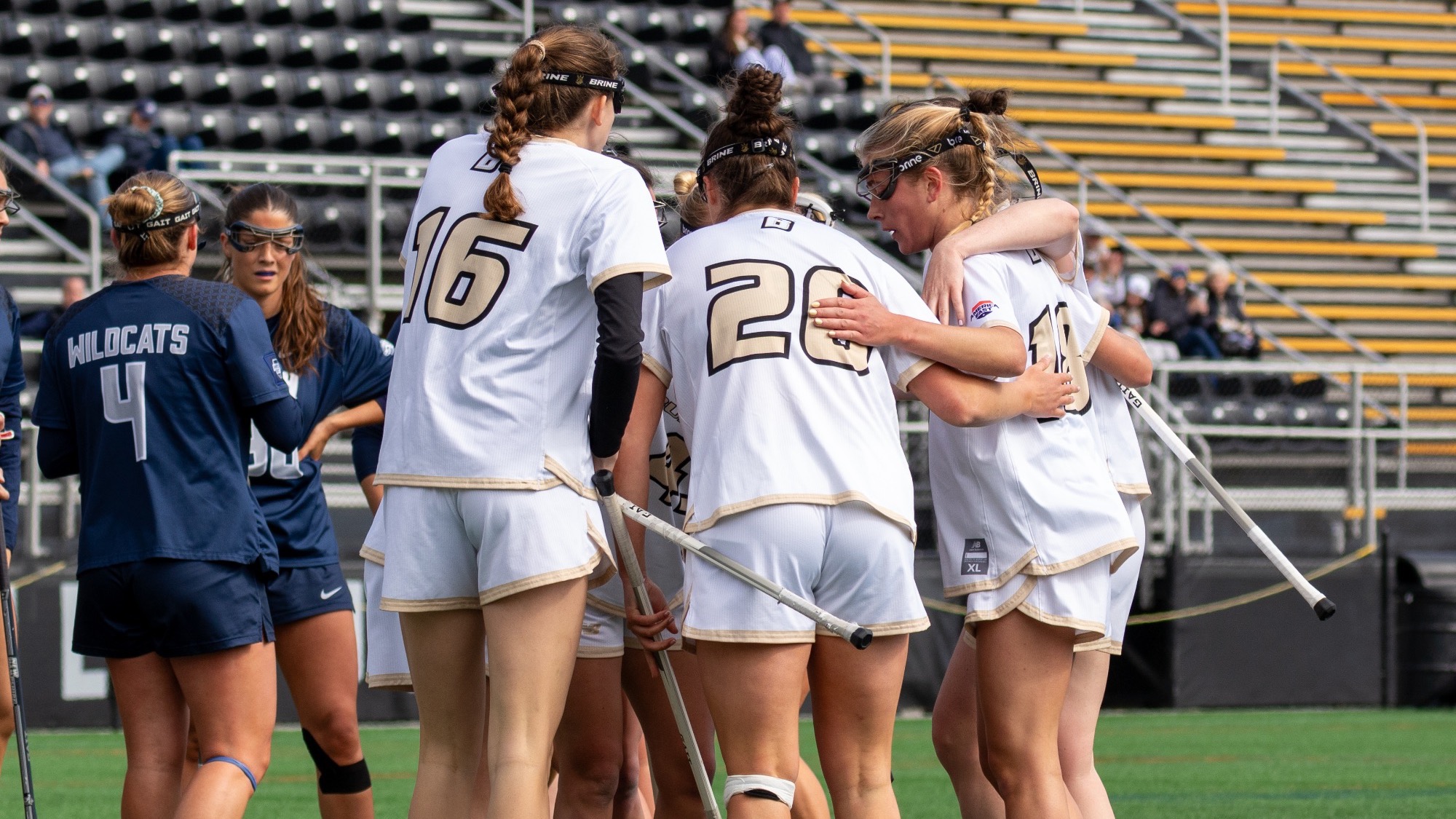 Team Huddles after a goal vs  UNH