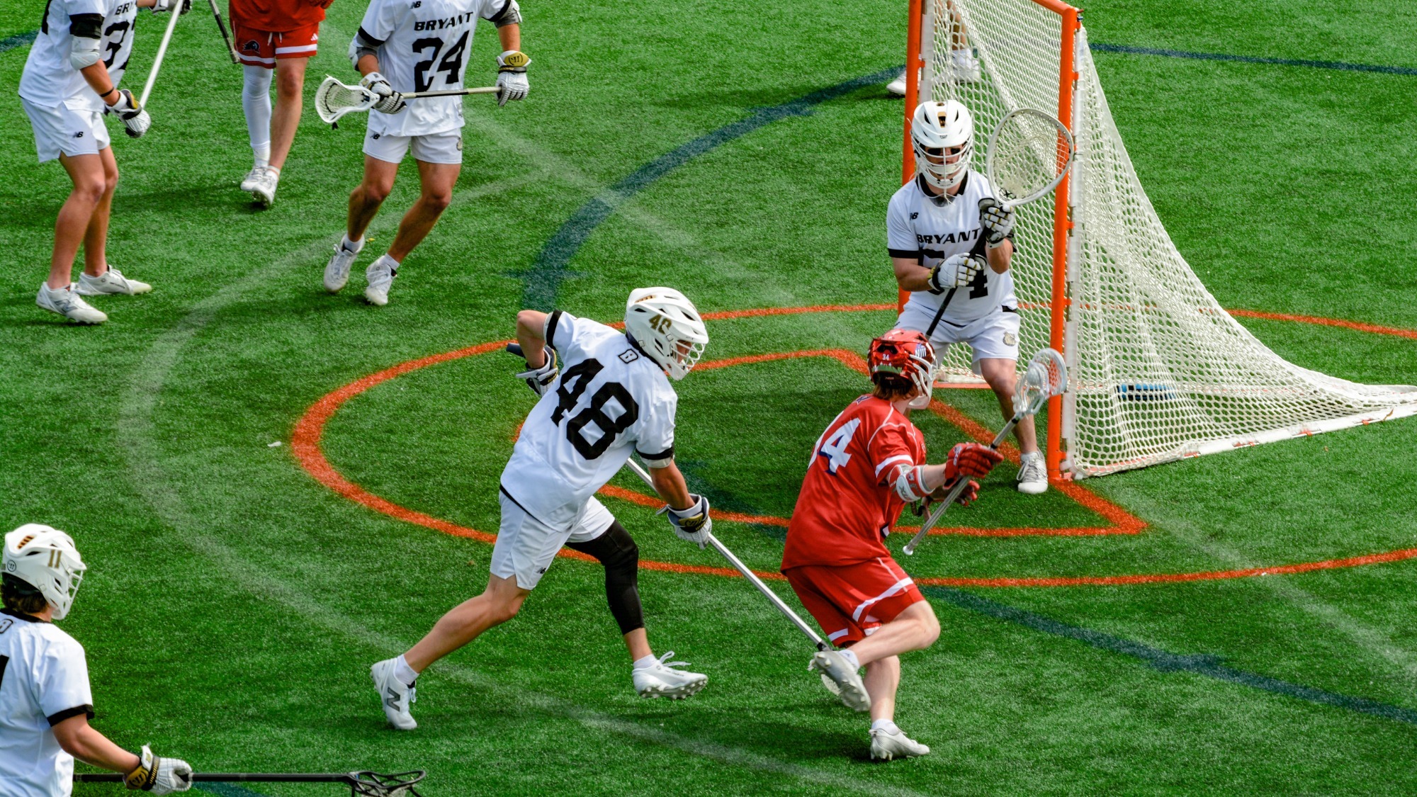 James Carr prepares to make a save against an NJIT attackman closing in on the right side