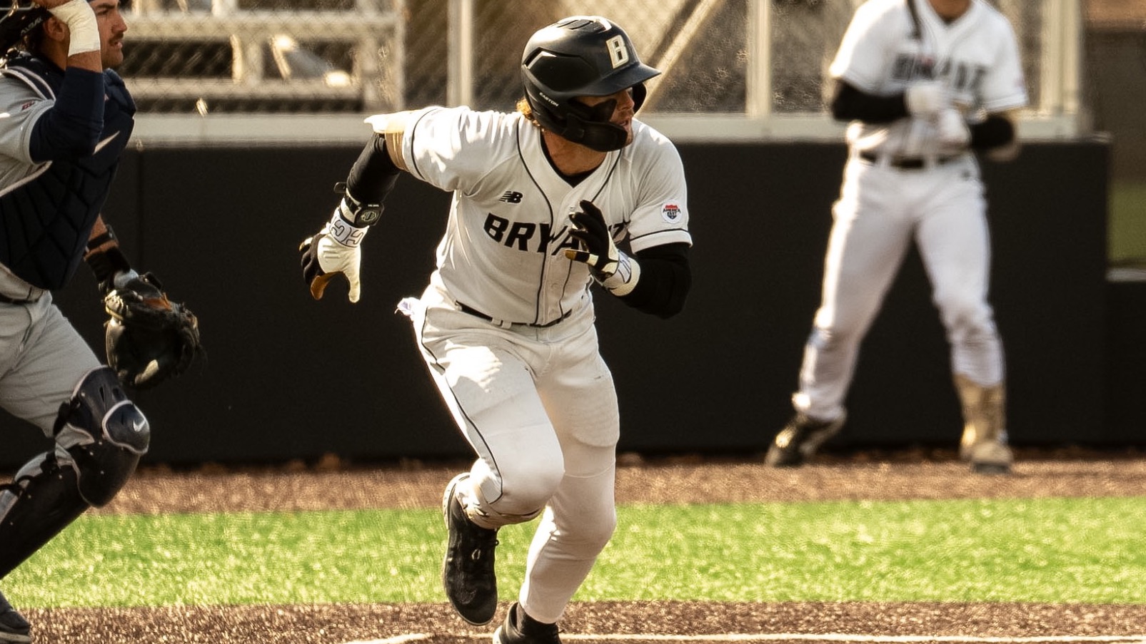 Gavin Greger runs up the first base line vs UConn