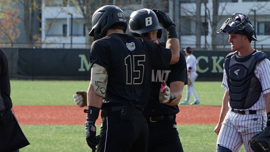Justin Hackett and Hunter Kingsbury hug at home vs MC