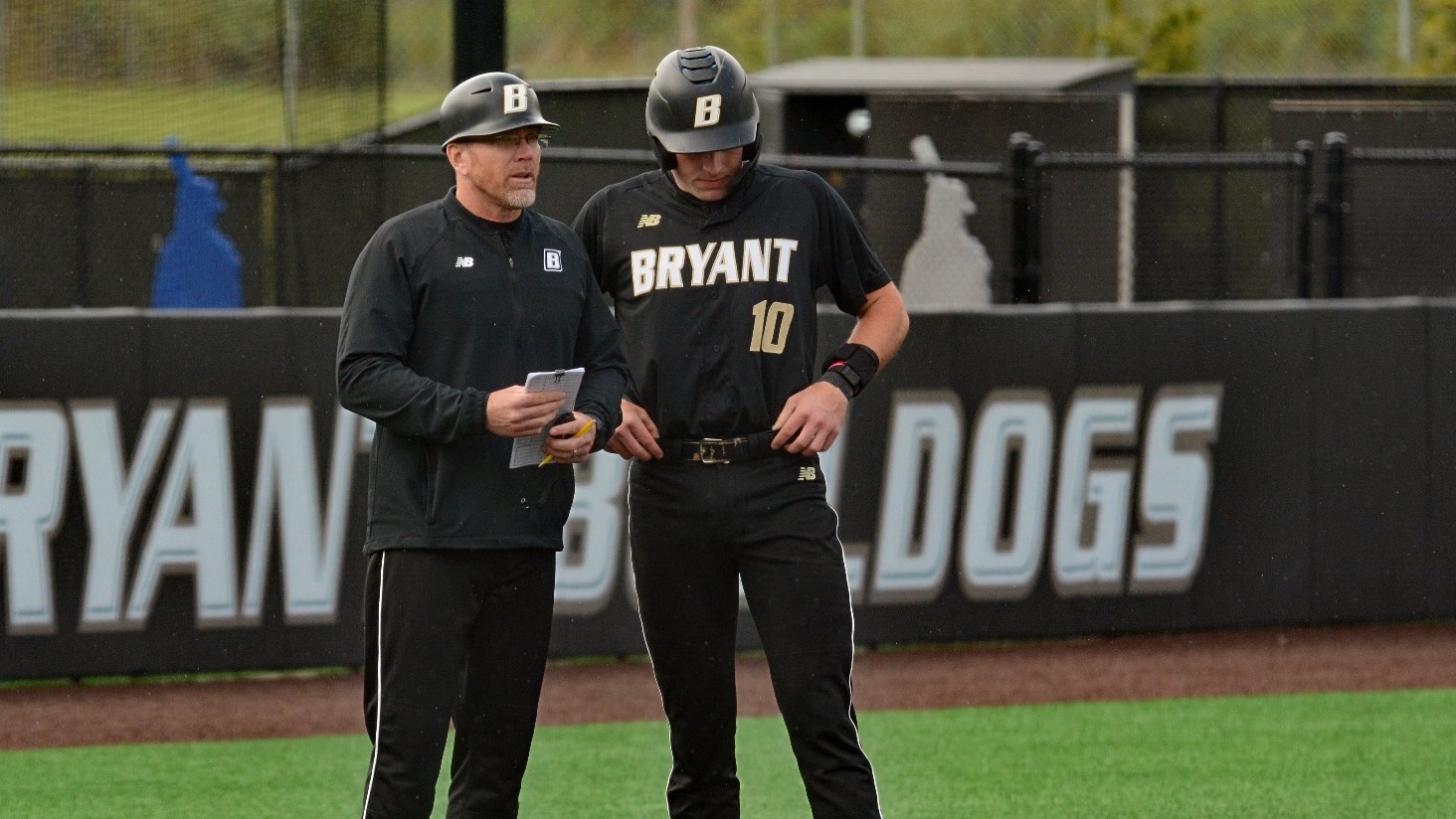 Cam and Coach stand at third base