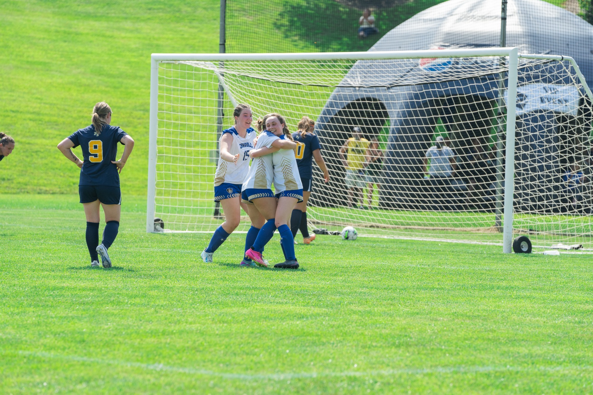 Greenwade hugs teammates after goal