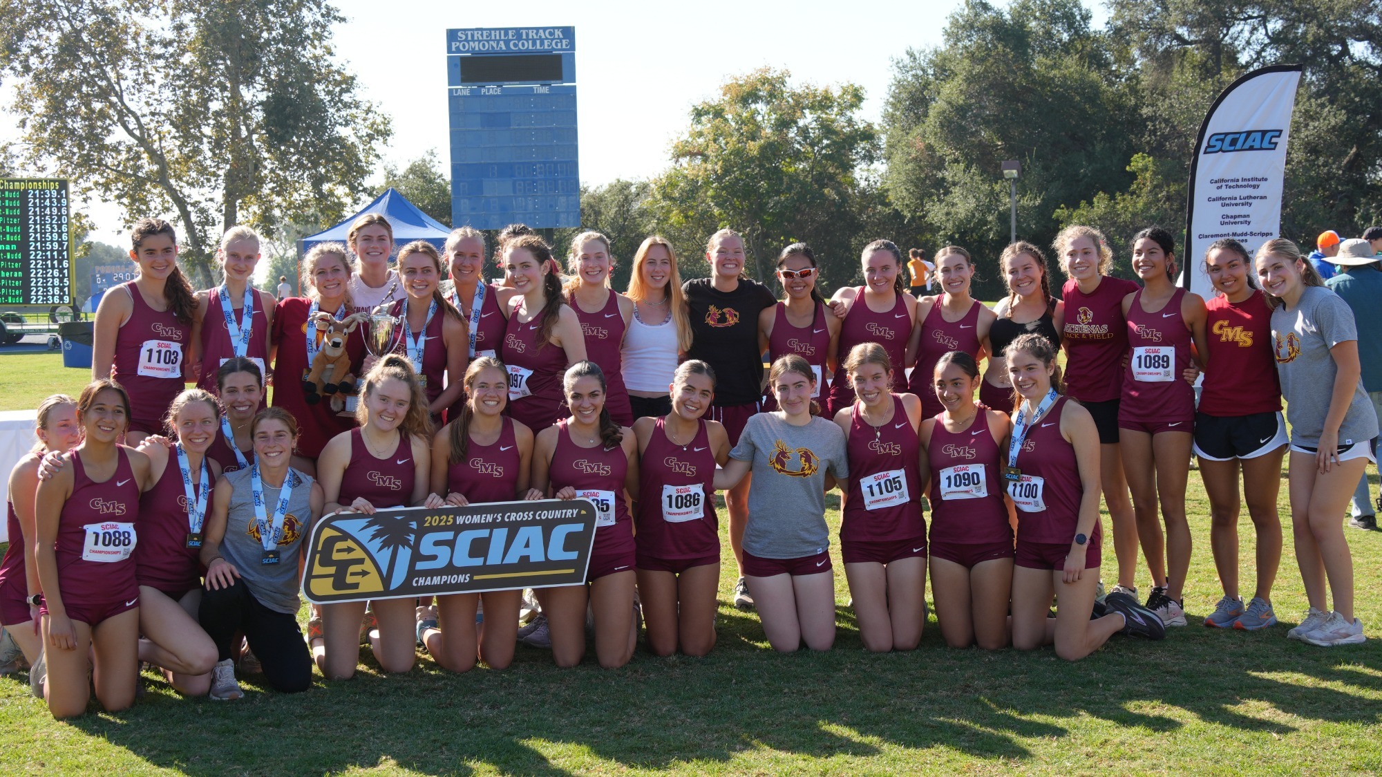 CMS Women's Cross Country poses with the SCIAC Championship banner
