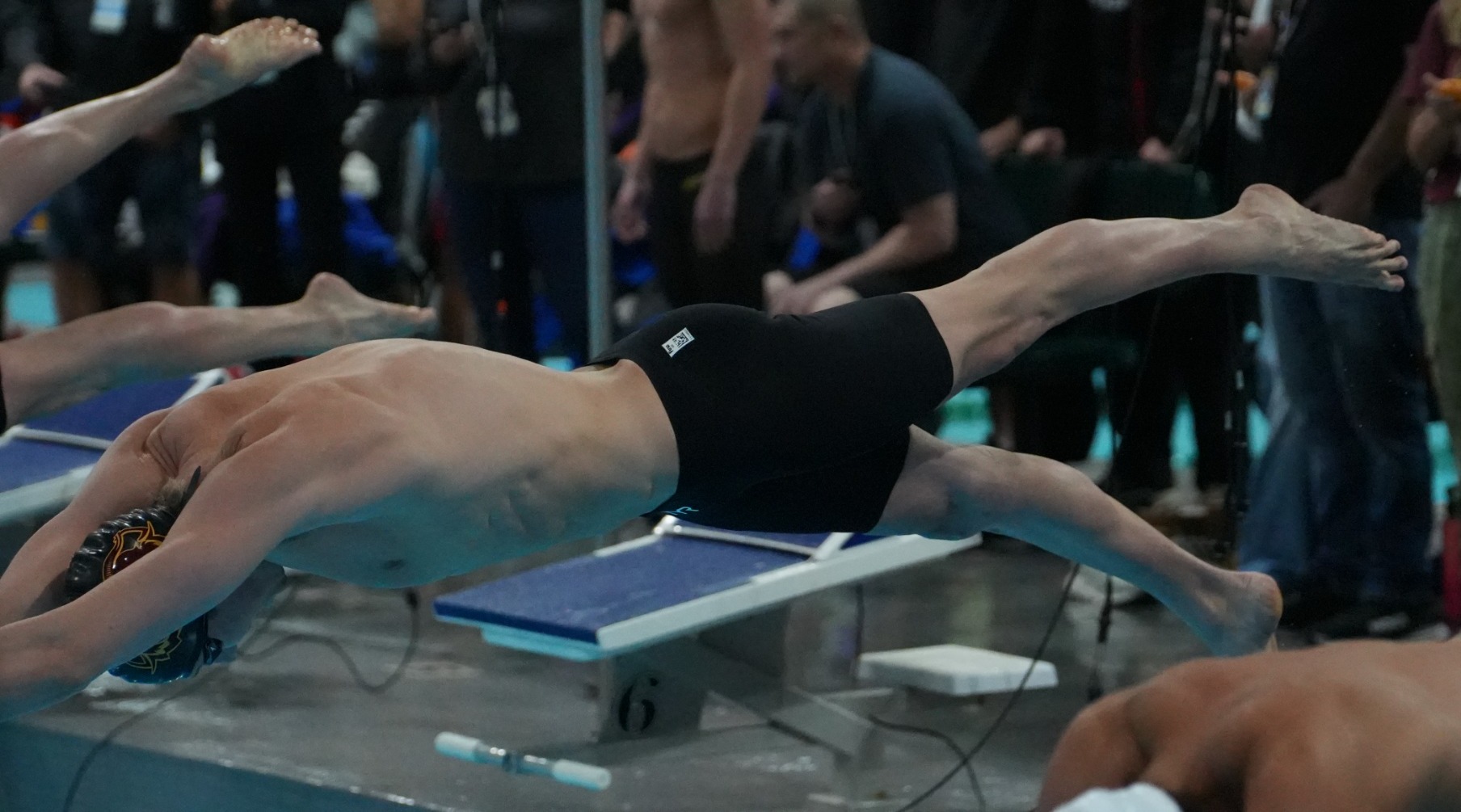 Theo Johnson diving in during a relay