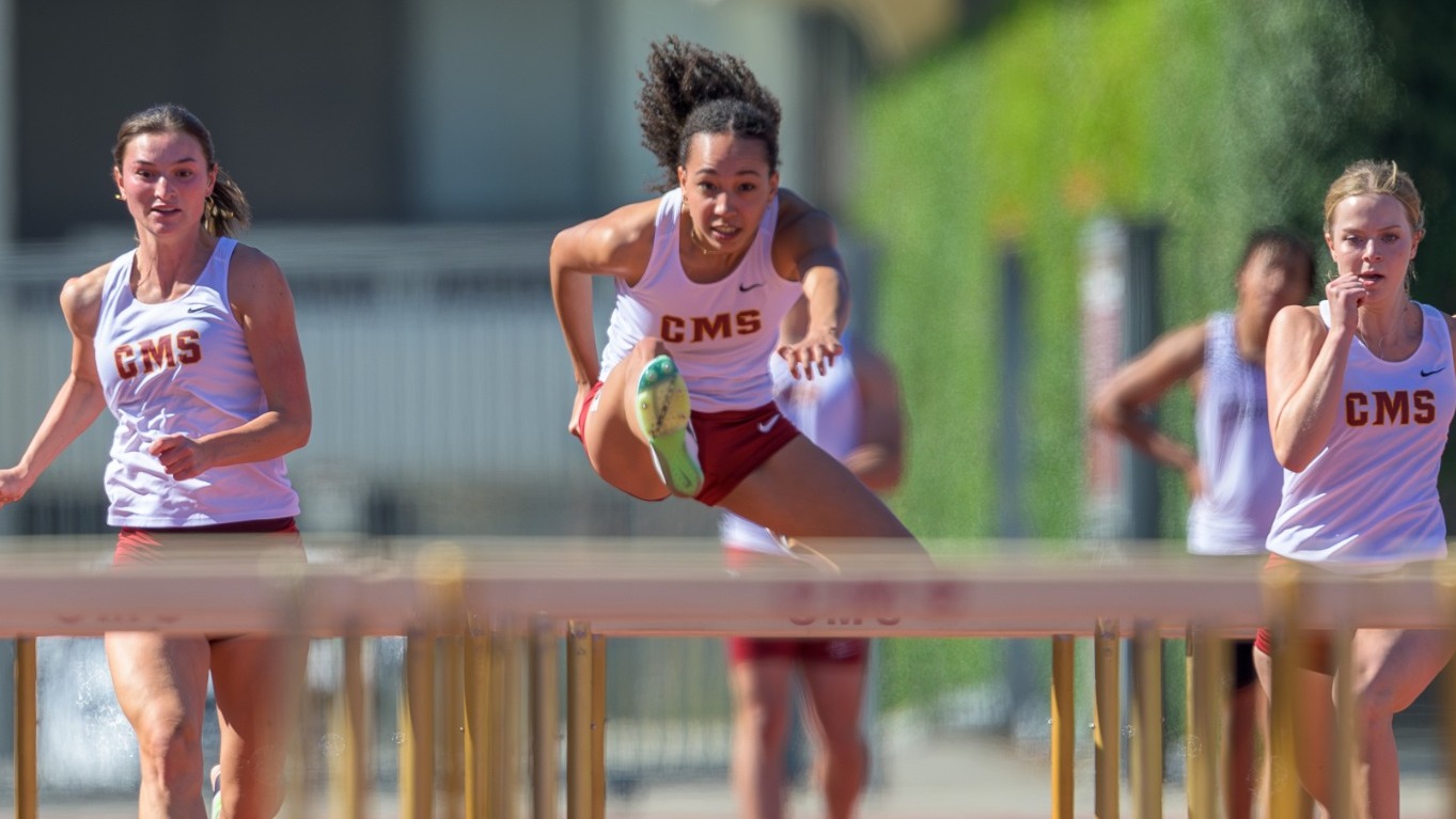 Josephine Jett clearing a hurdle