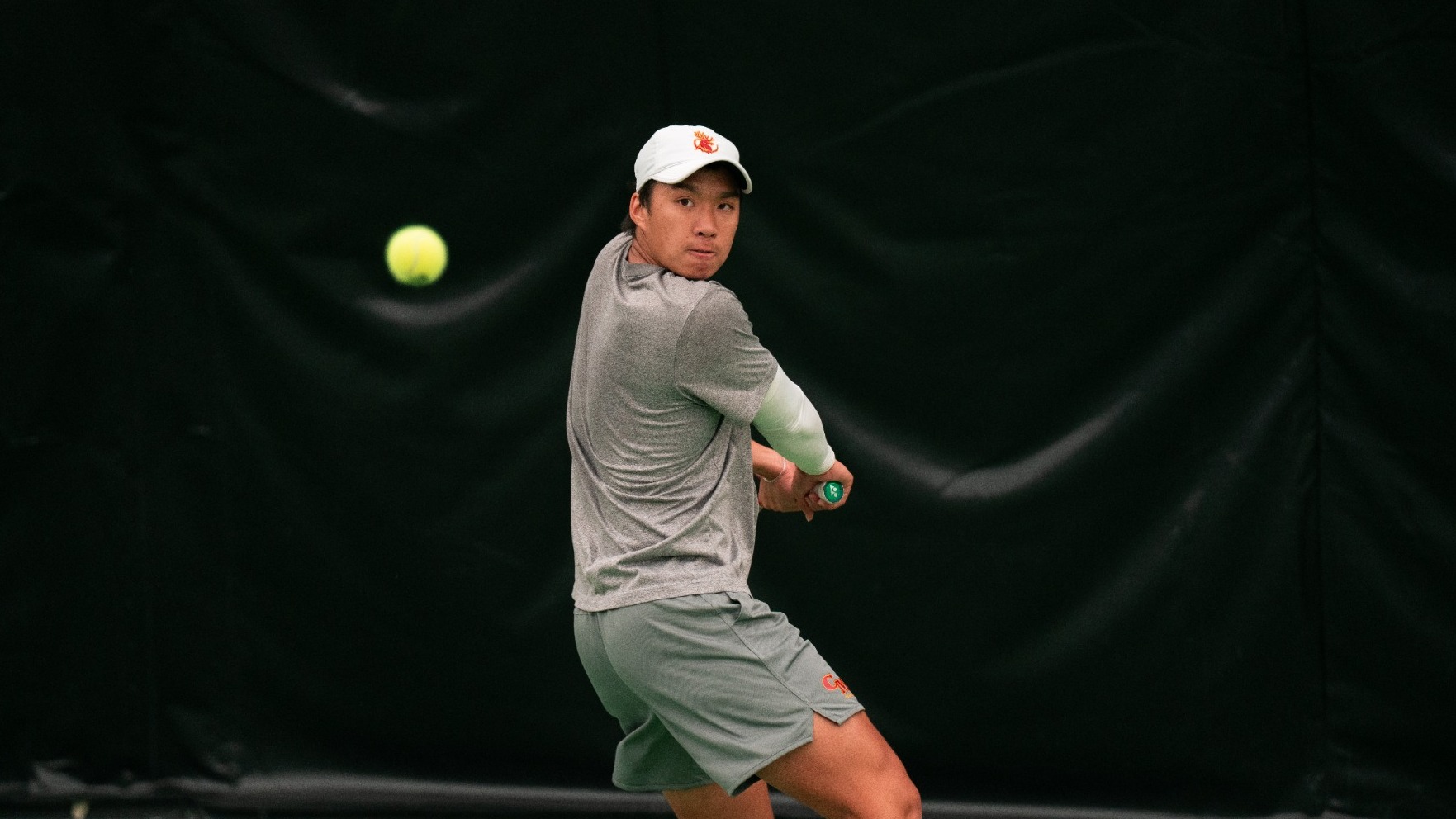 Warren Pham hitting a backhand