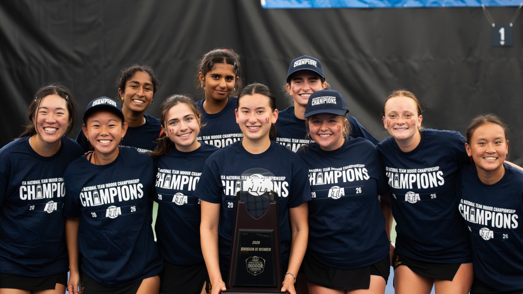 CMS women's tennis celebrates the ITA Indoor Championship with the trophy