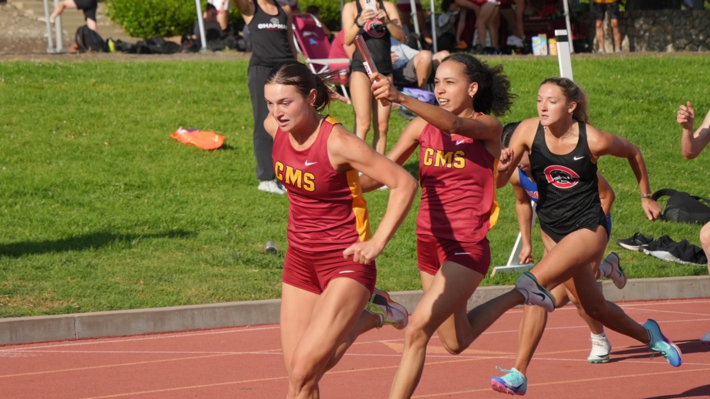Josephine Jett and Kaitlyn Creighton baton handoff
