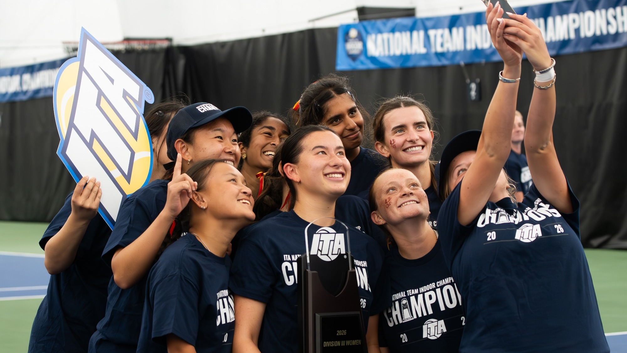 CMS Women's Tennis celebrating with the ITA Championship trophy