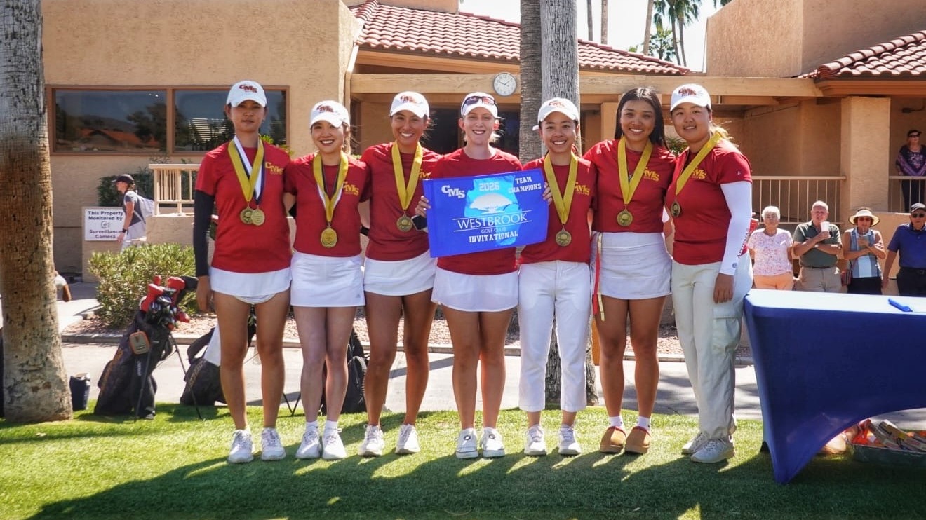 CMS Women's Golf holding the championship banner