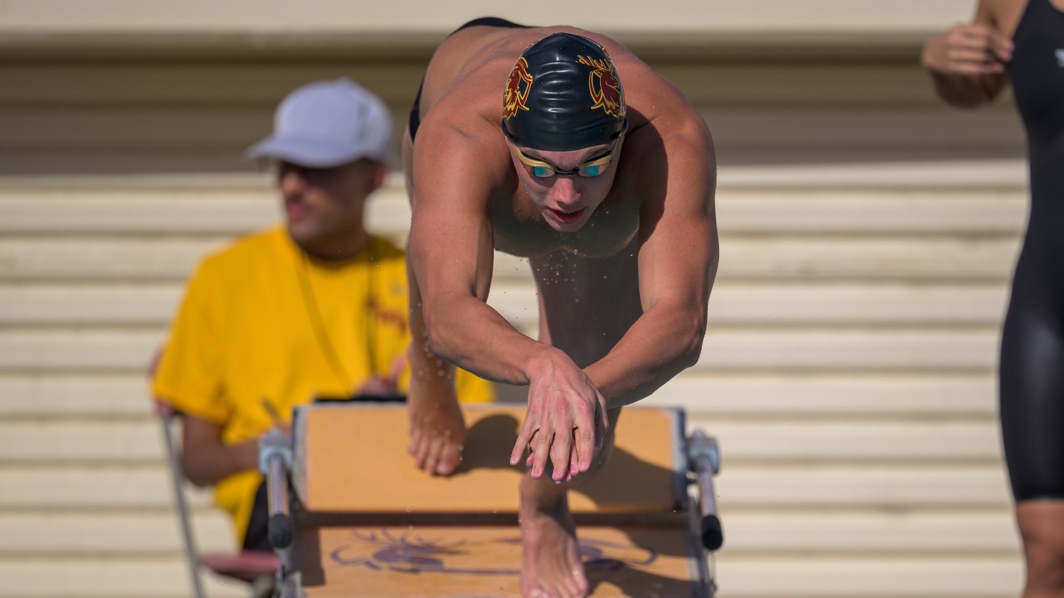 Charlie Bollwerk diving into the pool for a race