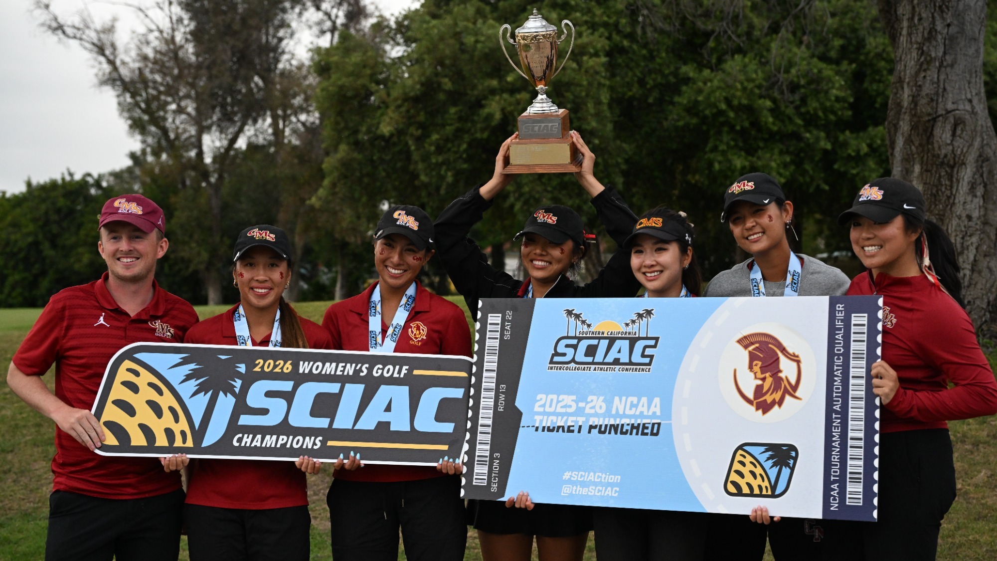 CMS Women's Golf holding the SCIAC Championship banner