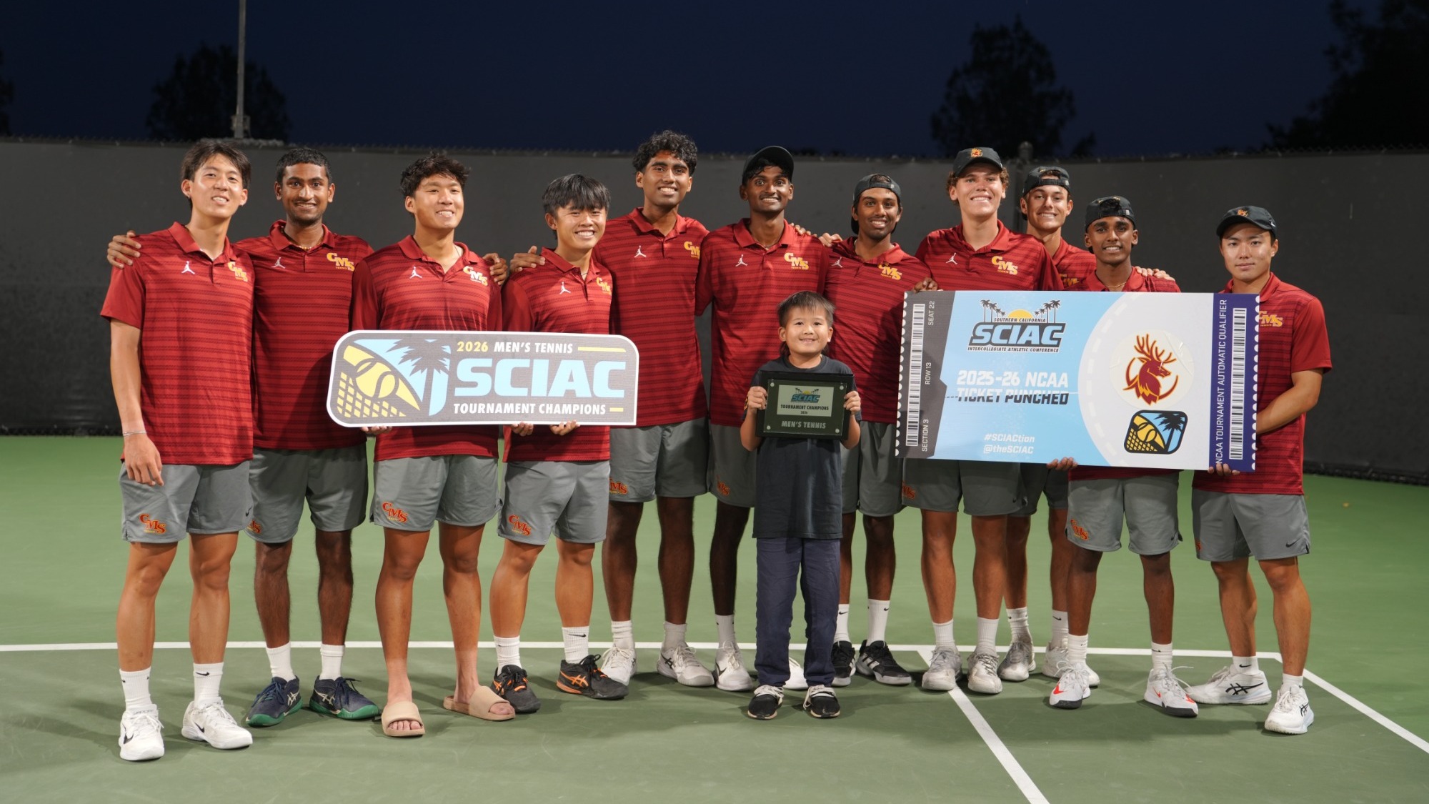 CMS Men's Tennis team with the SCIAC Championship banner