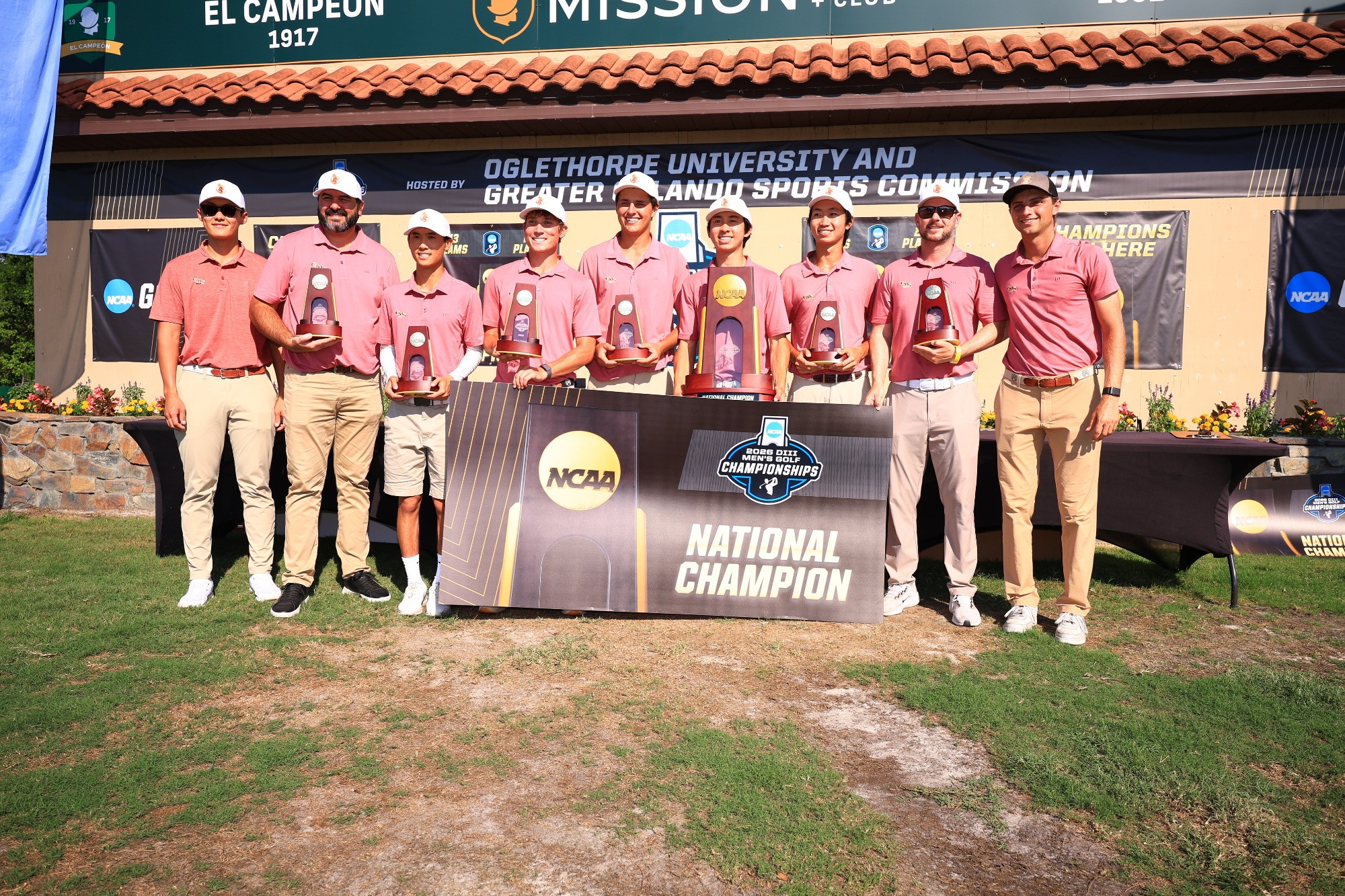 Stags Men's Golf with the national championship banner