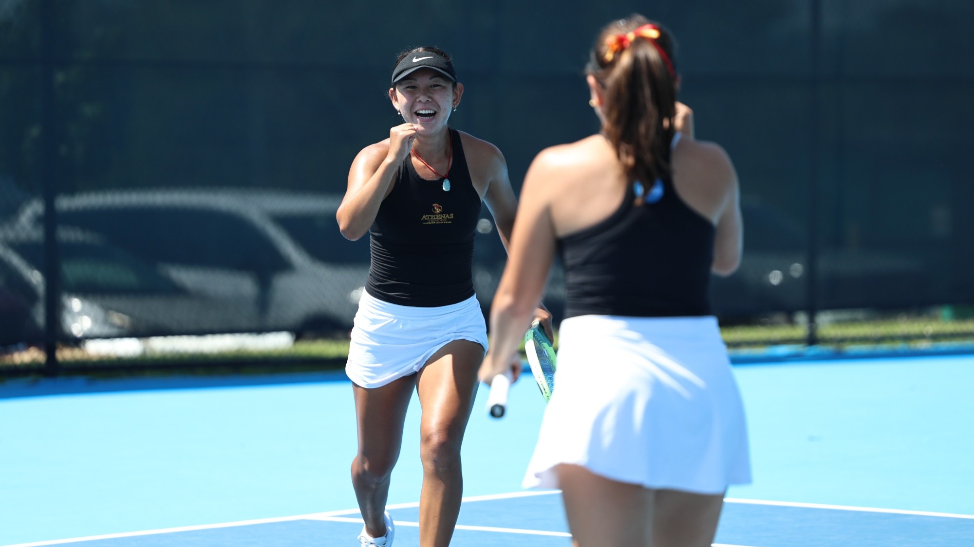 CMS Women's Tennis celebrating a doubles win