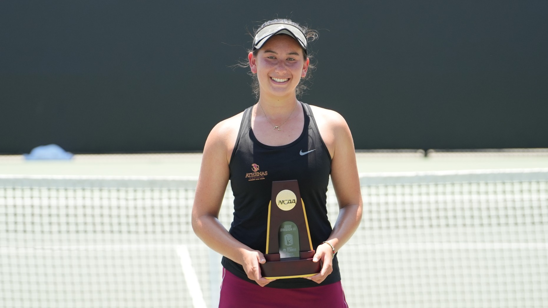 Lindsay Eisenman holding her NCAA singles championship trophy