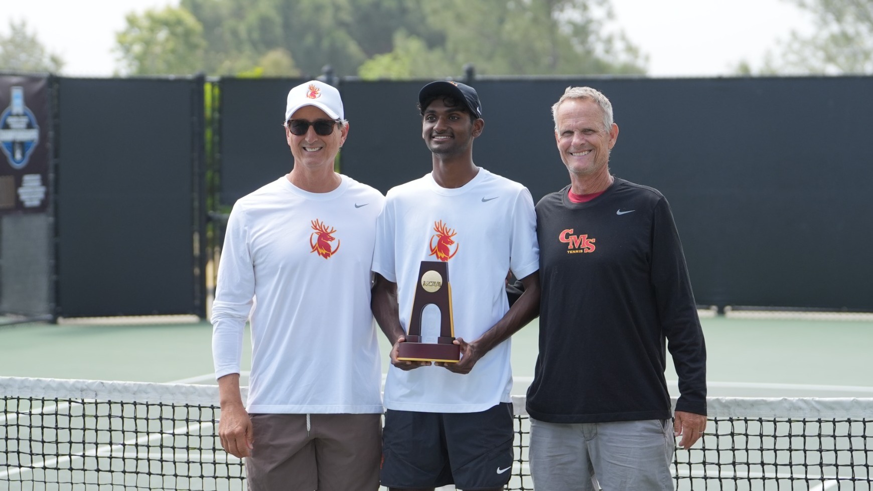 Advik Mareedu posing with his NCAA singles trophy