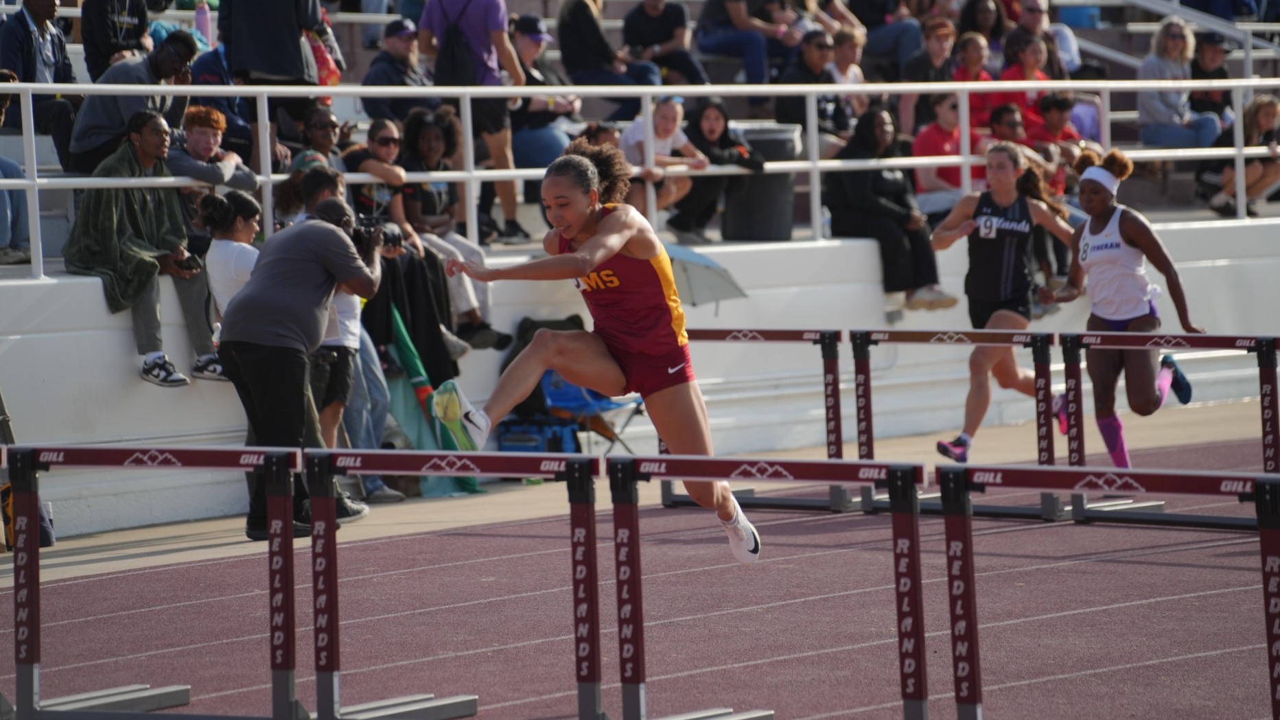 Josephine Jett clearing a hurdle