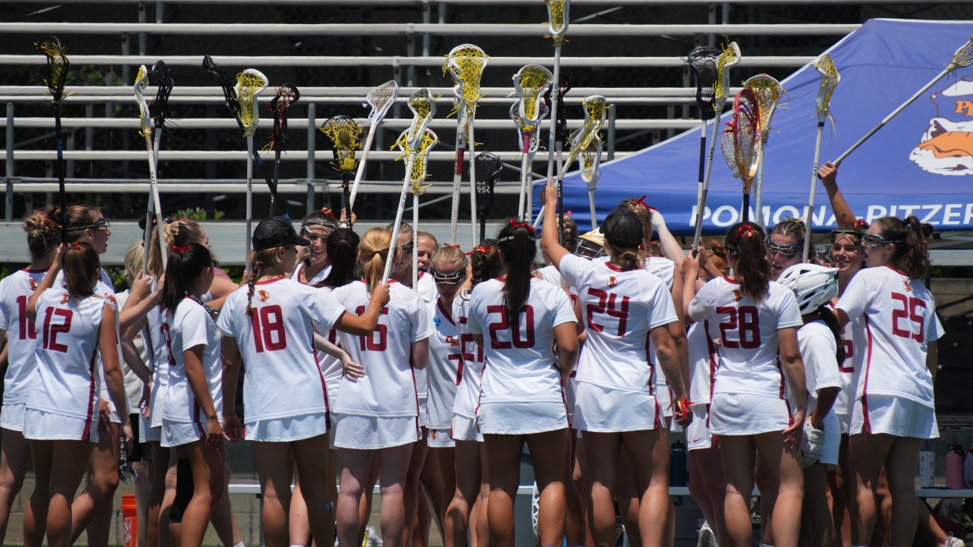 CMS Women's Lacrosse with their sticks in the air