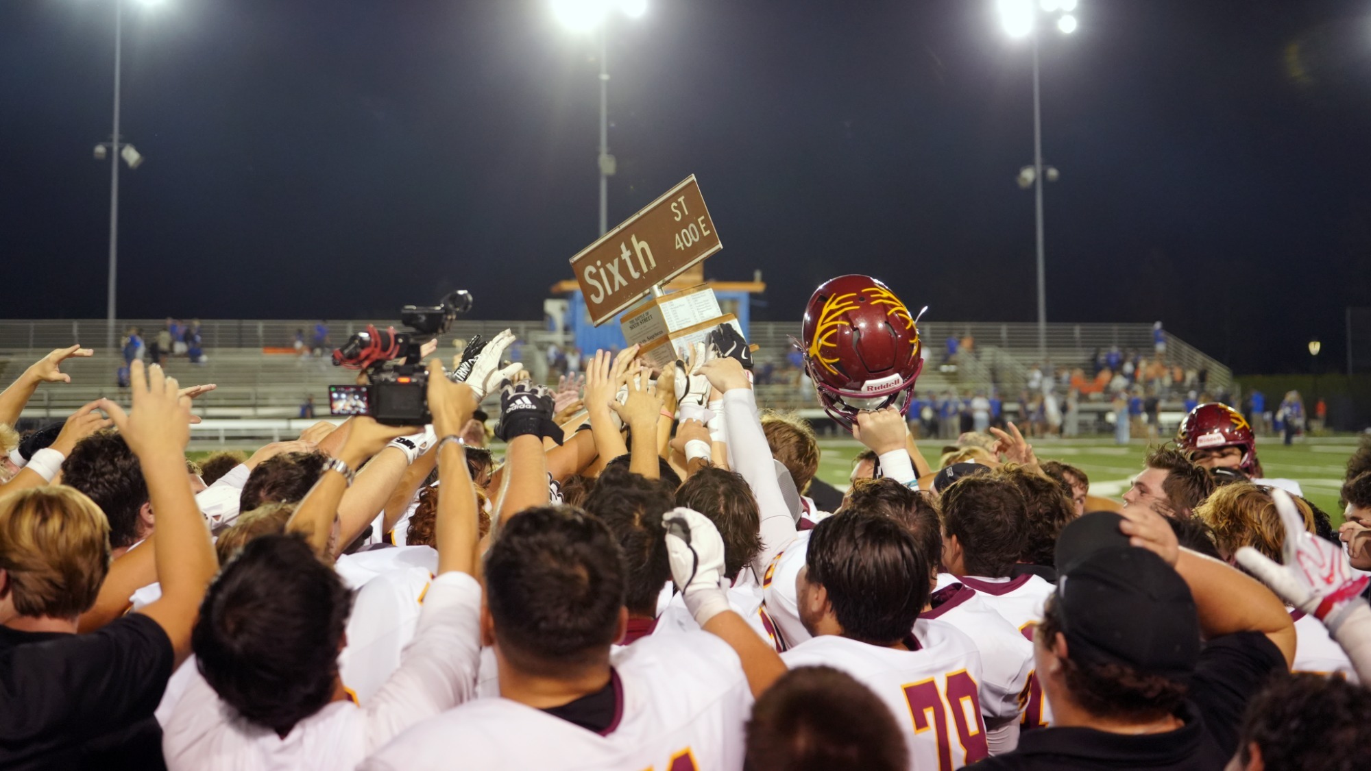 CMS Football celebrating with the Sixth Street Trophy