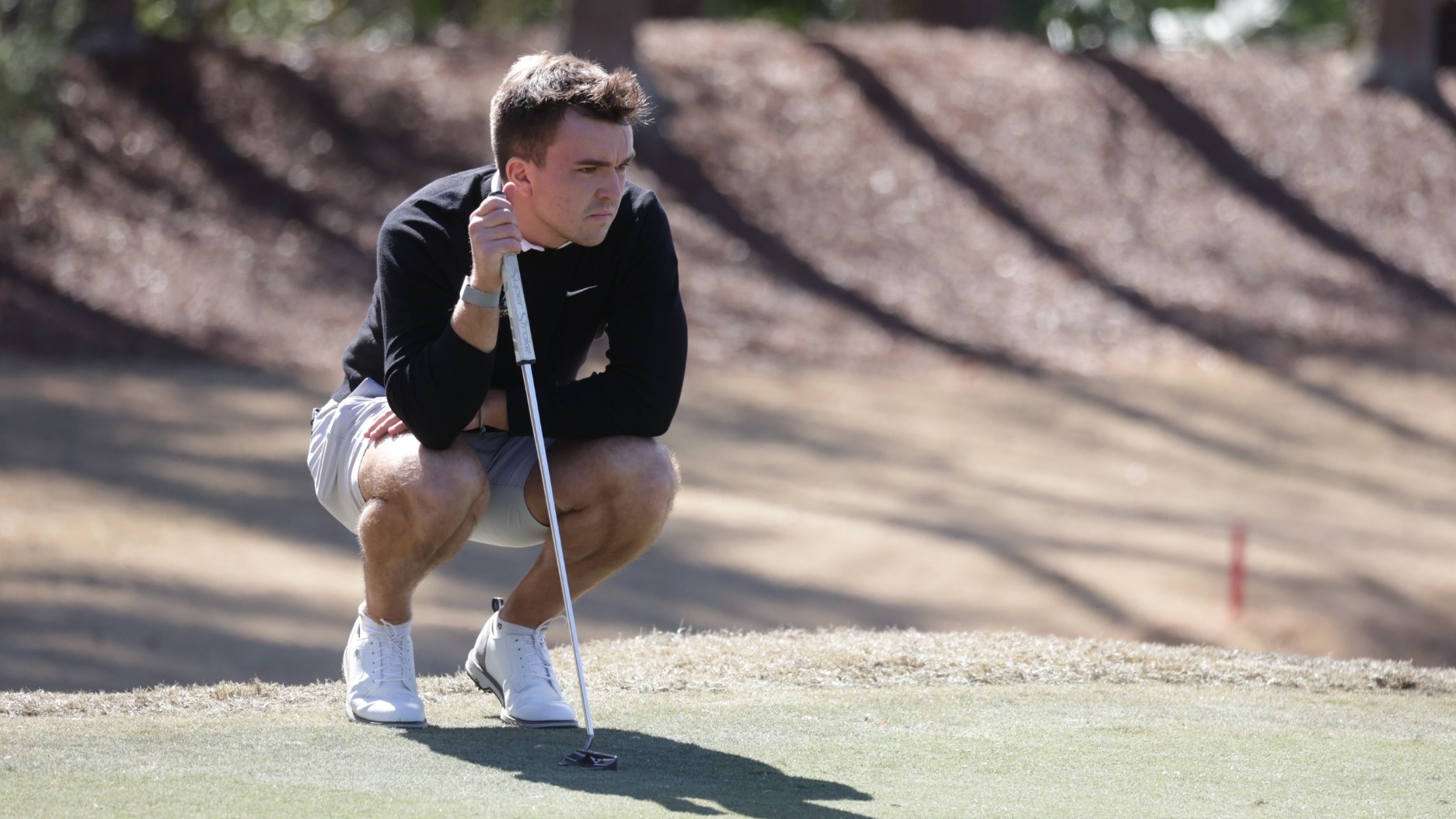 Dominik Cosic looks over a putt