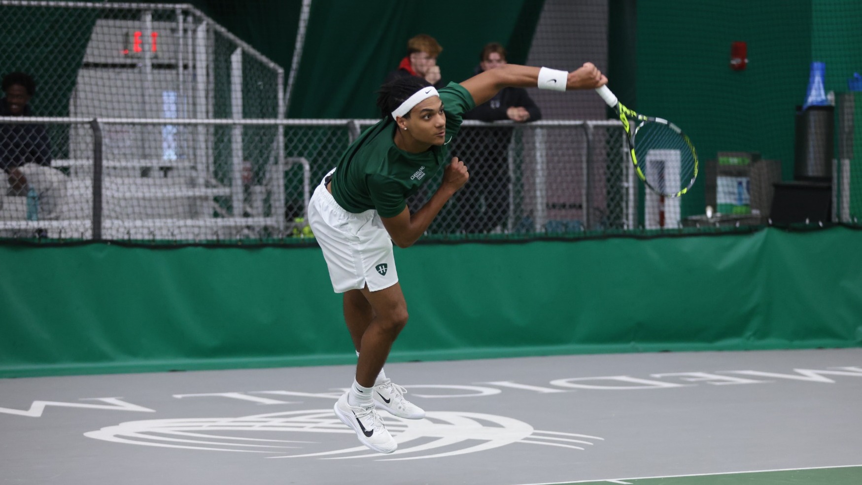 Maxime Aremon hits a serve