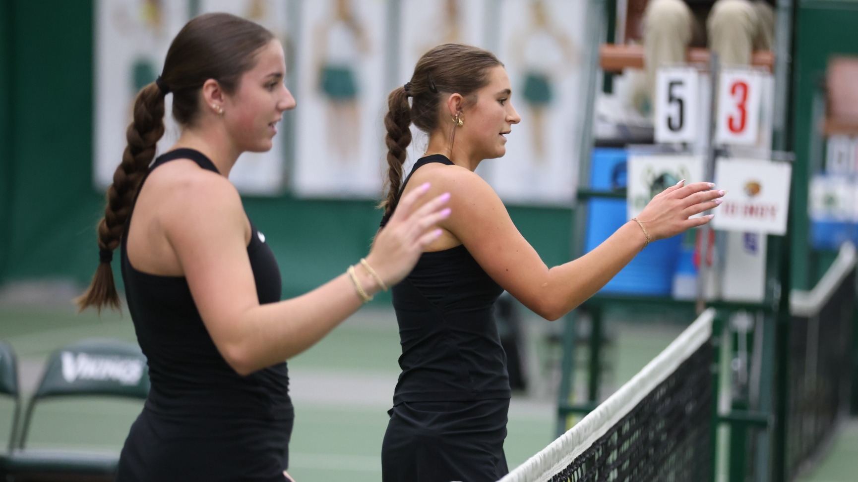 Doubles shake hands at net following match