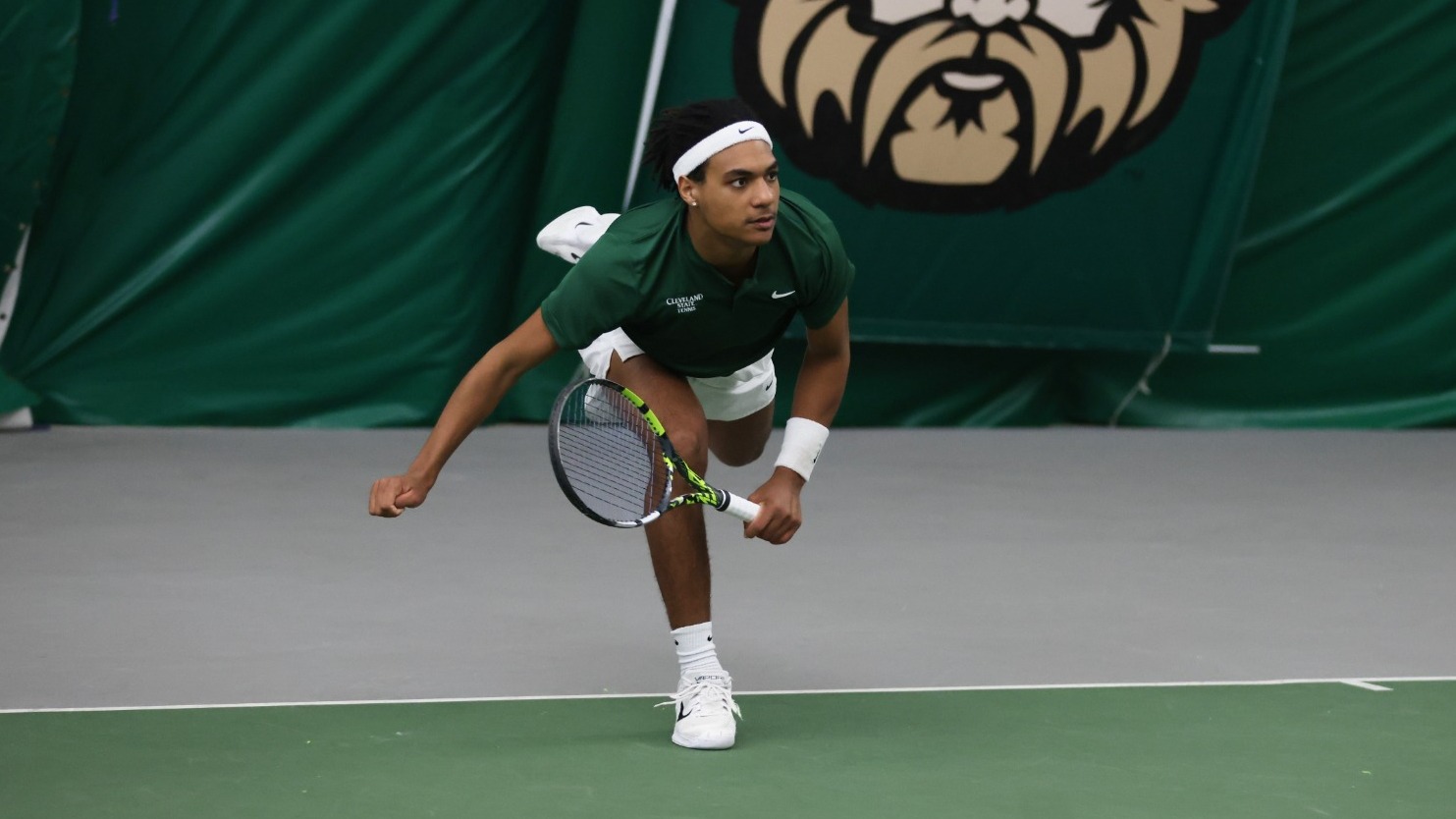 Maxime Aremon hits a serve