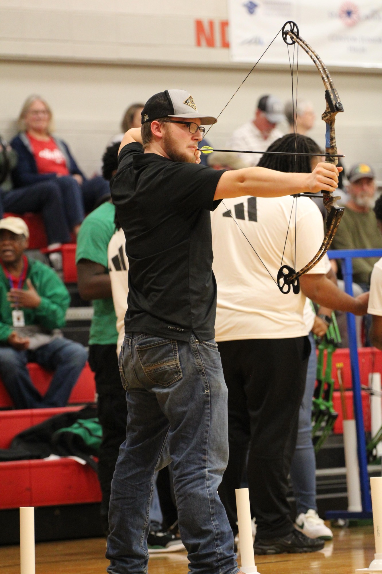 A Clinton Arrow archer aims at the target.