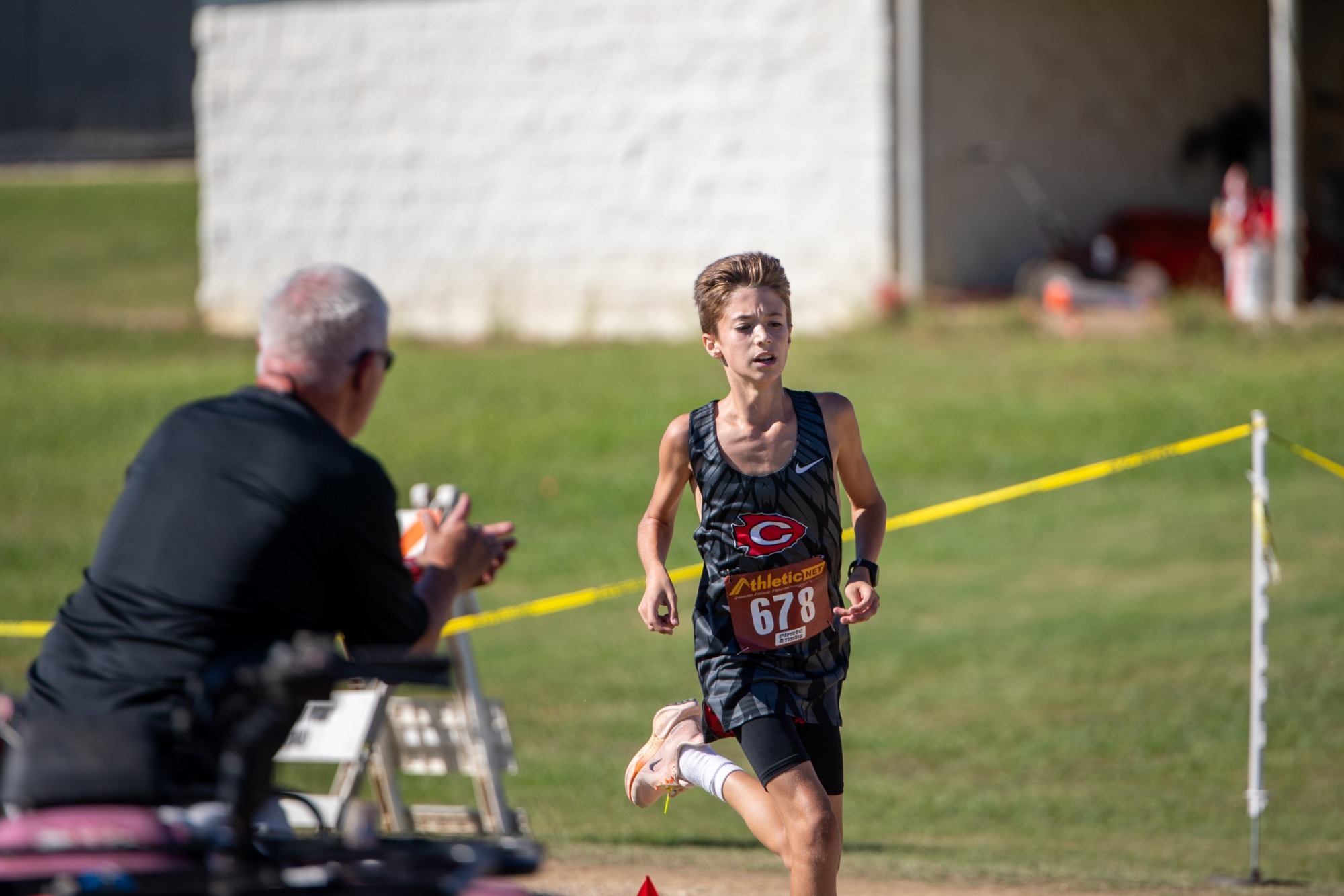 Eric Solis cheers on his runner at the Clinton Arrow Invitational.
