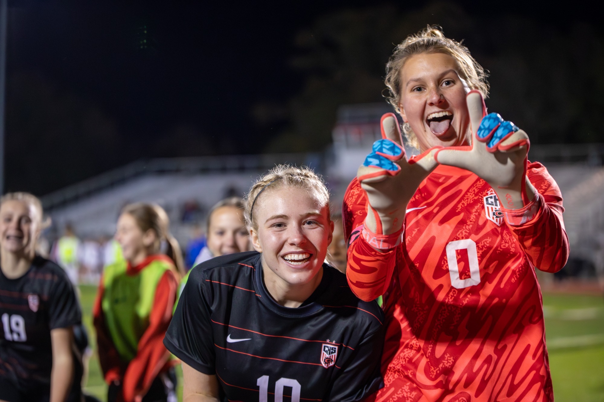Ellyn Burchfield and Carly Howell celebrate a victory over Madison Central after a nine-round shootout on Thursday, December 11, at Arrow Field.