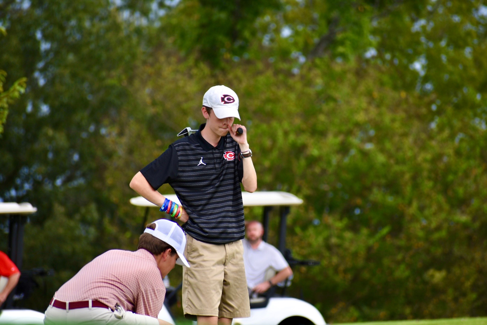 Williams Parry surveys the green at a golf tournament.