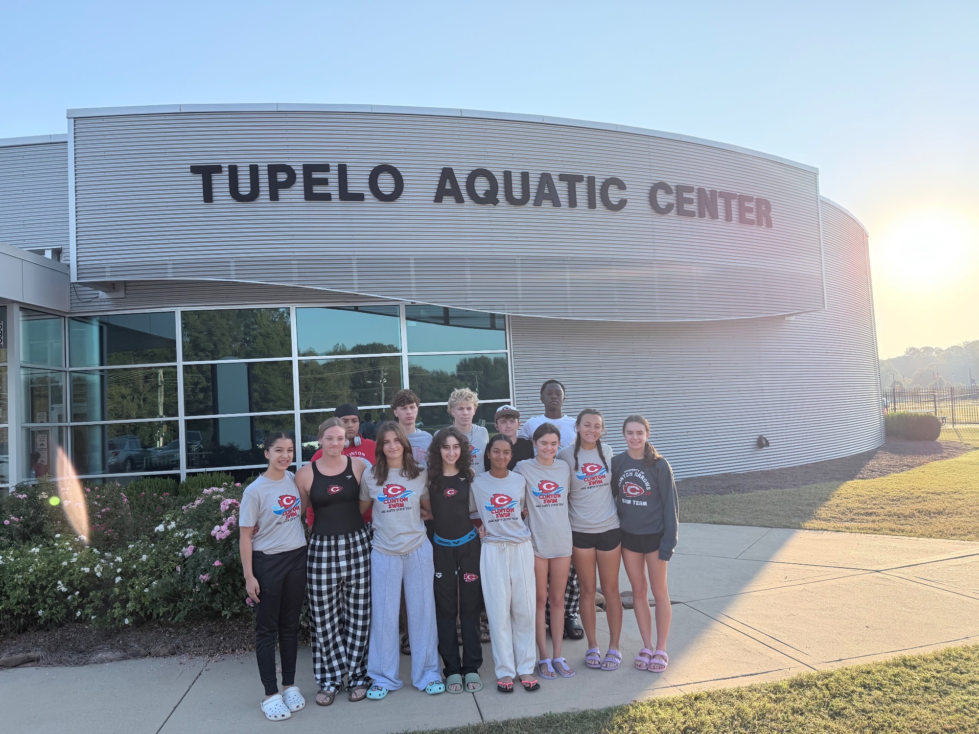 Clinton Arrows Swim Team members pose outside the Tupelo Aquatic Center on Friday, Oct. 16, prior to the MHSAA Class III State Championships in Tupelo.