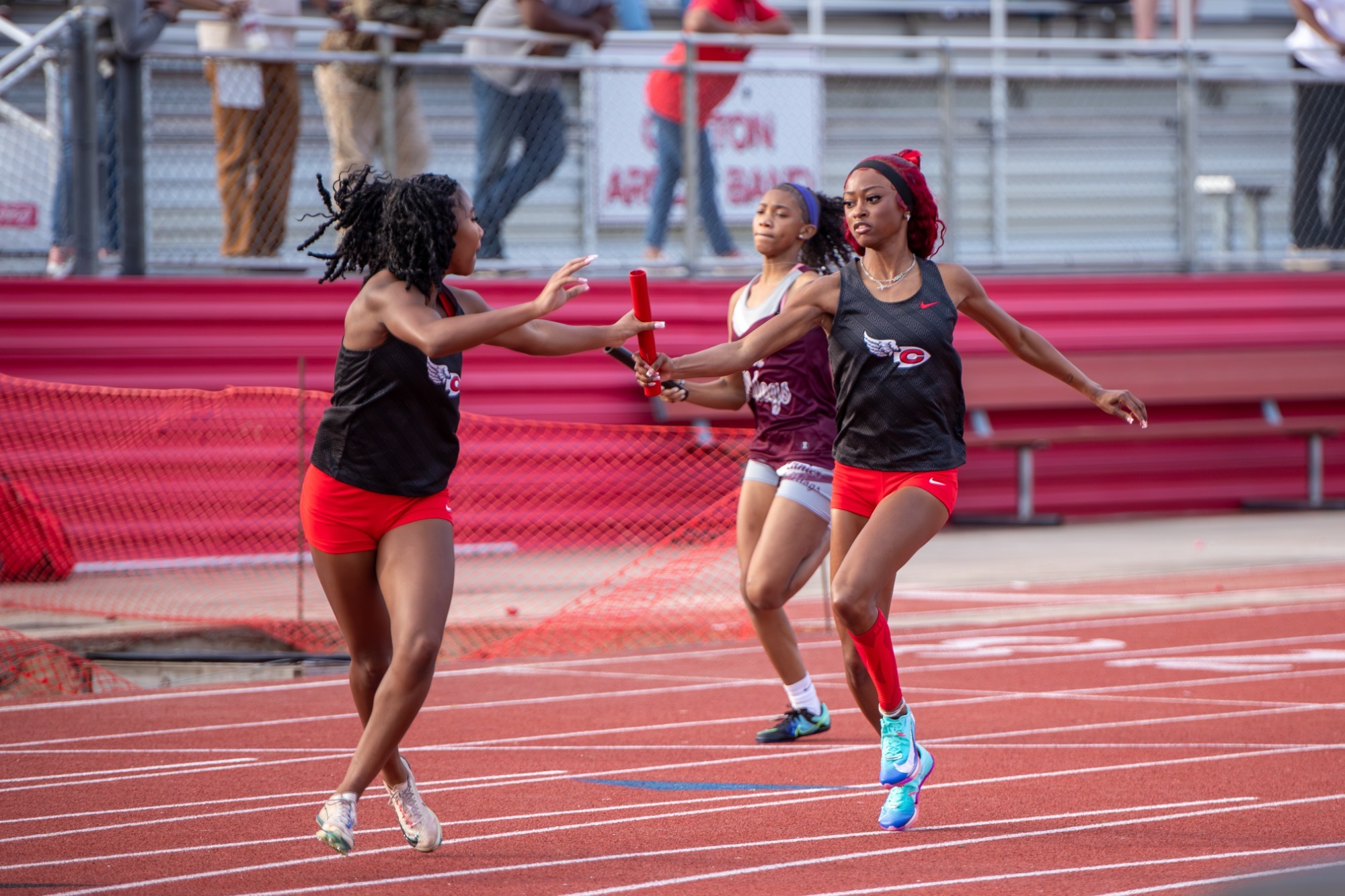 The Clinton High School Women's relay team makes an exchange during an event at the Clinton Season Opener on Friday, February 20, at Arrow Field.