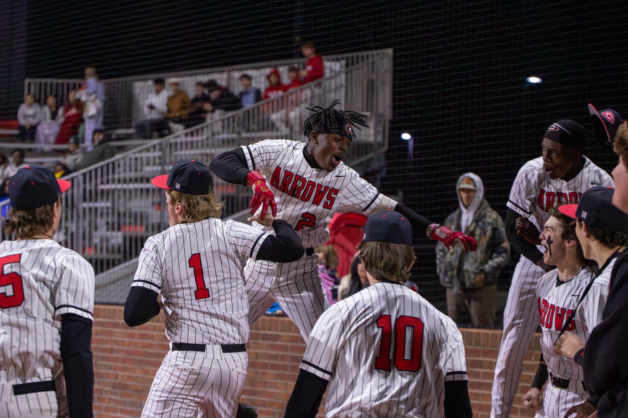 Chad Bates celebrates his three-run homerun with his teammates against Pearl on Tuesday, February 24, in Clinton.