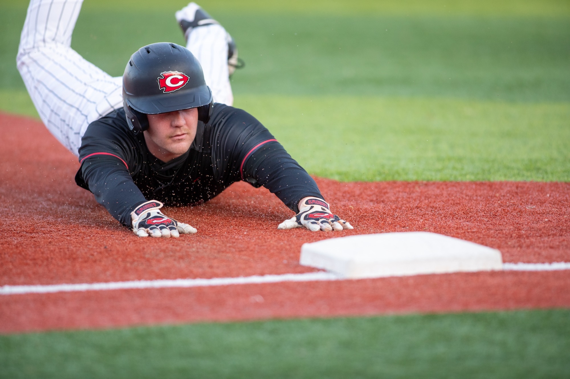 An Arrow Baseball player slides into third base against the Murrah Mustangs on Tuesday, March 17, in Clinton.