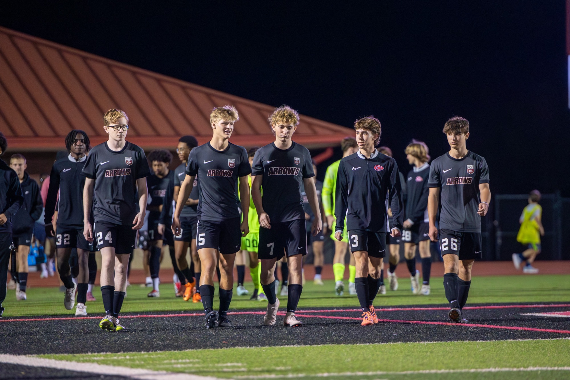 The Clinton High School Arrows exit the locker room at halftime during a first round playoff game against Tupelo.