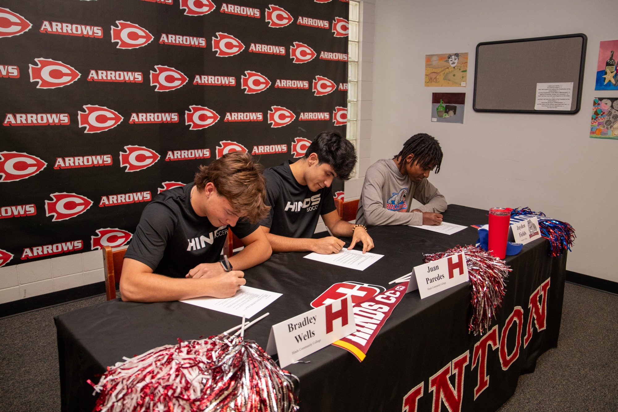 Clinton Arrow soccer players Jayden Fields, Juan Parades, and Bradley Wells each signed their national letters of intent to continue their soccer careers at the collegiate level during a signing ceremony on Monday, April 27.